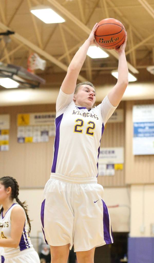 Julie Jansen hauls down a rebound for Oak Harbor Friday. (Photo by John Fisken)