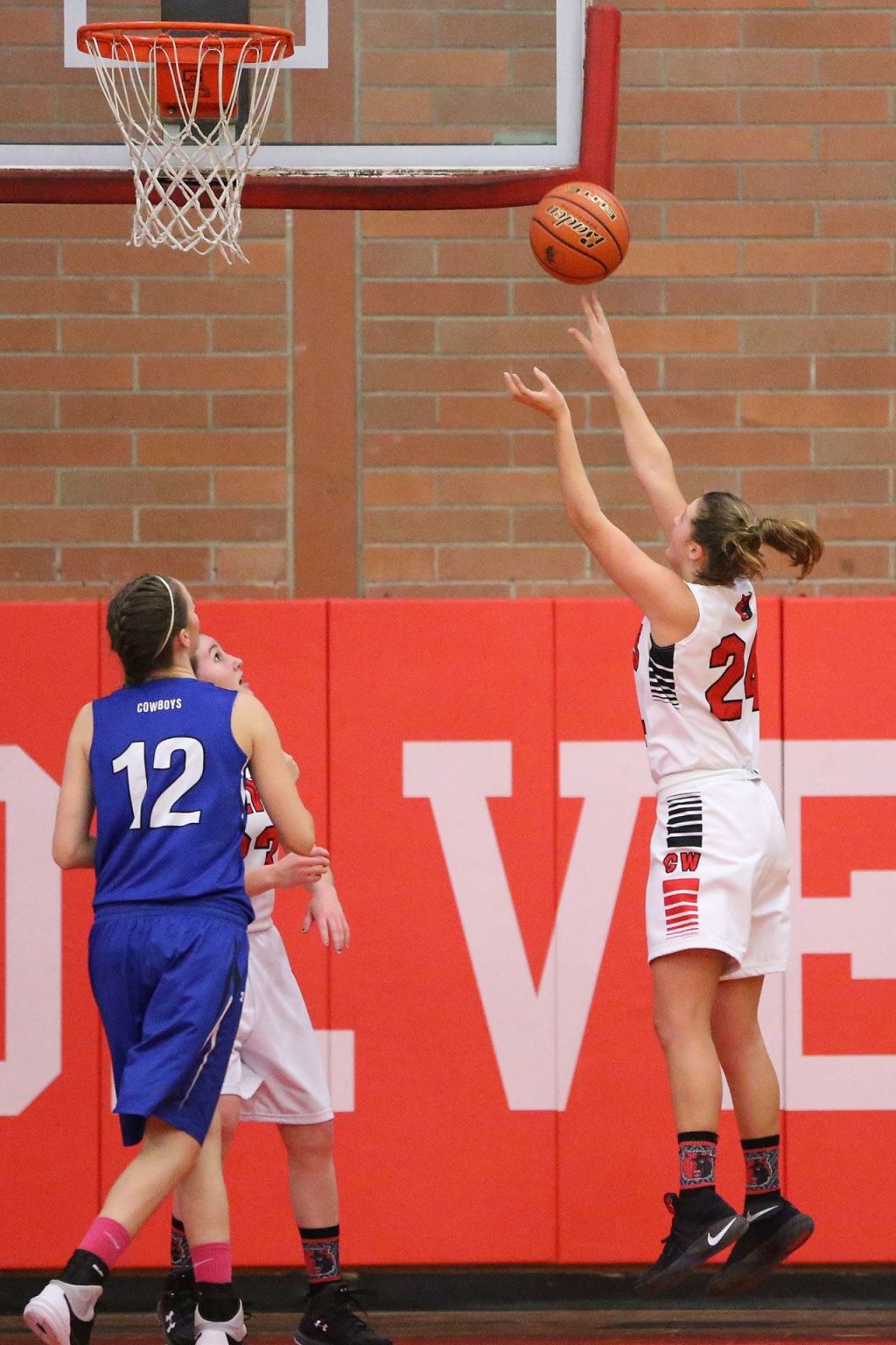 Lindsey Roberts records a bucket in Friday&rsquo;s win as Chimacum&rsquo;s Alice Yaley (12) looks on. (Photo by John Fisken)
