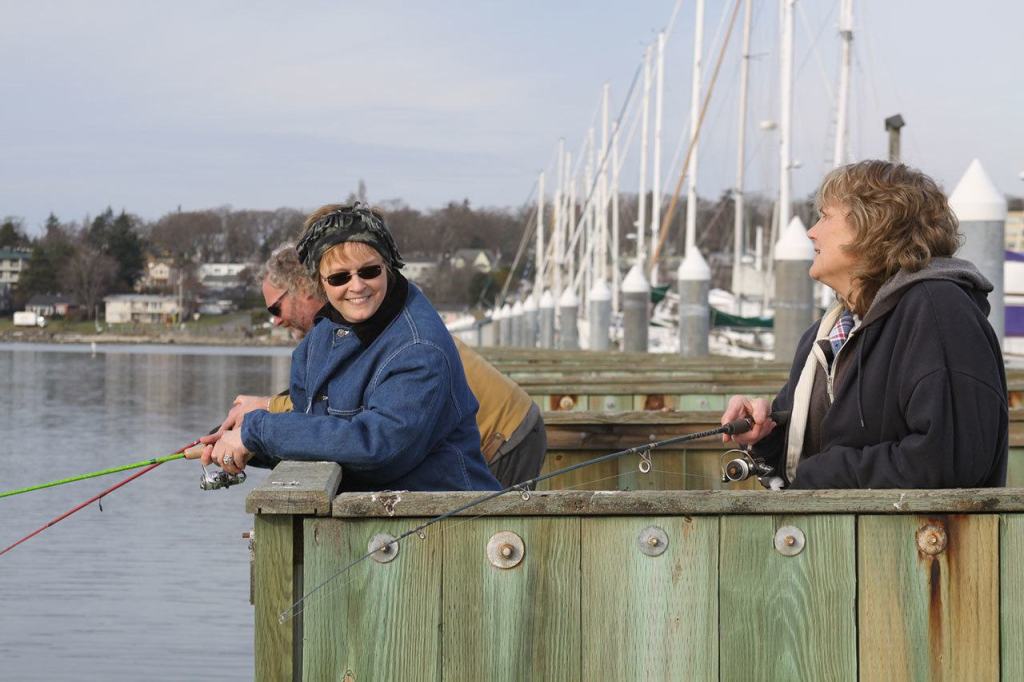 Cheryl Wieldraayer, left, her husband Ryan Wieldraayer, and sister-in-law Carol Sorg, jig for smelt at the Oak Harbor Marina Thursday, Jan. 26, 2017. Photo by Ron Newberry/Whidbey News-Times