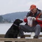 Dean Bannister tries a chum concoction to attract smelt but it also tends to get the attention of Molly, a labrador, Wednesday, Jan. 25, 2017. Photo by Ron Newberry/Whidbey News-Times
