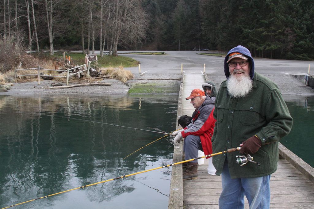 Lee Smith, right, shares a light moment with longtime fishing buddies Dean Bannister, center, and Rick Rumpff while jigging for surf smelt at Cornet Bay Wednesday, Jan. 25, 2017. Photo by Ron Newberry/Whidbey News-Times