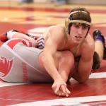 Ethan Pace turns Stanwood&rsquo;s Cole Carrigan on the way to a 12-1 win. (Photo by John Fisken)