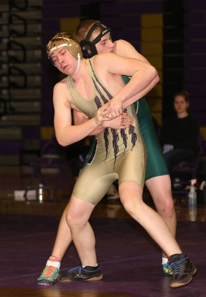 Trevor Vaughn works on an escape in his 8-2 win over Marysville Getchell&rsquo;s Cooper Armstrong. (Photo by John Fisken)