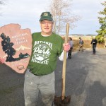 Rob Smith, a member of the National Parks Conservation Association holds up a dilapidated National Park Service sign and a broken shovel Monday, at Prairie Wayside in Coupeville, to show the condition of many things in need of repair or replacement in the National Park System. Smith and the NPCA were participating in a partner volunteer project along with Mission Continues, a veterans and active duty service members who spent their Martin Luther King holiday donating their time and work to the community. Photo by Michael Watkins/Whidbey News-Times