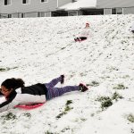 Olivia Gunter, front, sleds with Lauren Piel, left, and Irene Gunter Monday in Oak Harbor. Photo by Michael Watkins/Whidbey News-Times