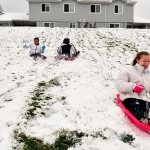 Lauren Piel, right, sleds with Irene Gunter and Olivia Gunter Monday in Oak Harbor.                                 Lauren Piel, right, sleds with Irene Gunter and Olivia Gunter Monday in Oak Harbor.