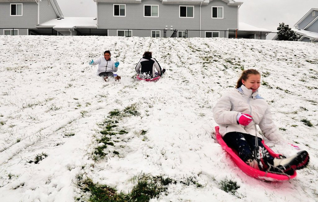 Lauren Piel, right, sleds with Irene Gunter and Olivia Gunter Monday in Oak Harbor.                                 Lauren Piel, right, sleds with Irene Gunter and Olivia Gunter Monday in Oak Harbor.