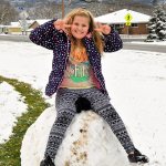 Alexis Black sits on a giant snowball in Oak Harbor, making the most out of the accumulated snow Monday. See more snow day photos on page 20 of today&rsquo;s Whidbey News-Times.