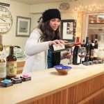 Owner Hollie Swanson pours a sample of red wine at Greenbank Farm Wine Shop. The $1/per glass tastings are popular with both locals and visitors. The store specializes in Whidbey Island wine. Photo by Patricia Guthrie/Whidbey News-Times