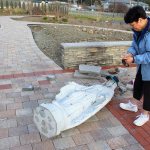 Theresa Frazer looks over the damage to the Mary statute at St. Augustine Catholic Church in Oak Harbor. Wednesday night, vandals knocked over the 5-foot tall granite statute that&rsquo;s the centerpiece of the new Prayer Garden. Photo by Patricia Guthrie/Whidbey News-Times