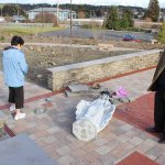 Rev. Paul Pluth and parishoner Theresa Frazer examine the damage to the Mary statue that was knocked over Wednesday night in the Prayer Garden at St. Augustine Catholic Church in Oak Harbor. Photo by Patricia Guthrie/Whidbey News-Times