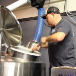 Photo by Jessie Stensland / Whidbey News-Times                                Mitch Aparicio of Penn Cove Brewing stirs a mixture of grain and water during the process of making a new IPA at Bastion Brewing Company in Anacortes Feb. 1.