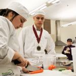 Sydney Dickinson, left, Garrett Karney and other Oak Harbor High School students work on knife skills while preparing dishes during Chef Mary Arthur&rsquo;s culinary arts class Thursday, Feb. 23, 2017. The school&rsquo;s culinary arts team won a state championship for the eighth time in 12 years on Saturday and will now advance to the National ProStart Invitational in Charleston, S.C. Photo by Ron Newberry/Whidbey News-Times