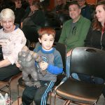 At Oak Harbor Library&rsquo;s Sasquatch talk, Brayden Meadows, center, shows off his &ldquo;King Kong&rdquo; doll, which he imagines is Sasquatch. His parents, Jason and Carrie Meadows, right, supervise. Photo by Daniel Warn/Whidbey News-Times