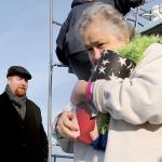 Kevin Clark / The Herald                                Celia Strong carries the ashes of her husband, Alfred Hollenbeck, to the rail for scattering.