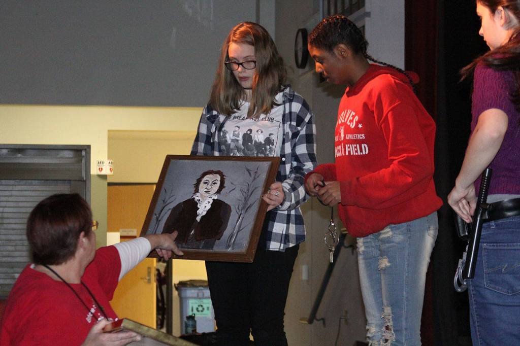 Members of Coupeville High School&rsquo;s Wolf PAC Theatre Troupe go over a prop during rehearsal for &ldquo;Arsenic and Old Lace&rdquo; at Coupeville&rsquo;s Performing Arts Center Monday night, Feb. 27, 2017. Photo by Ron Newberry/Whidbey News-Times