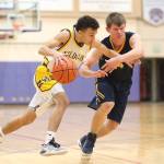 Oak Harbor&rsquo;s Haven Brown dribbles by Burlington-Edison&rsquo;s Taino Ferninand. Brown led Oak Harbor with 14 points and nine rebounds. (Photo by John Fisken)