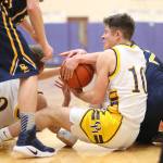 JJ Mitchell (10) and Adam Nelson (32) scrap for a loose ball. (Photo by John Fisken)