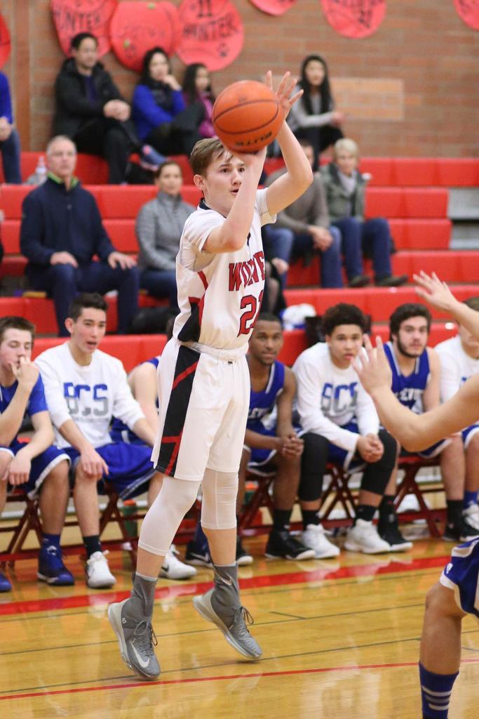 Ethan Spark puts up a three-pointer for the Wolves. (Photo by John Fisken)