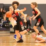 Kalia Littlejohn steals the ball for the Wolves. (Photo by John Fisken)