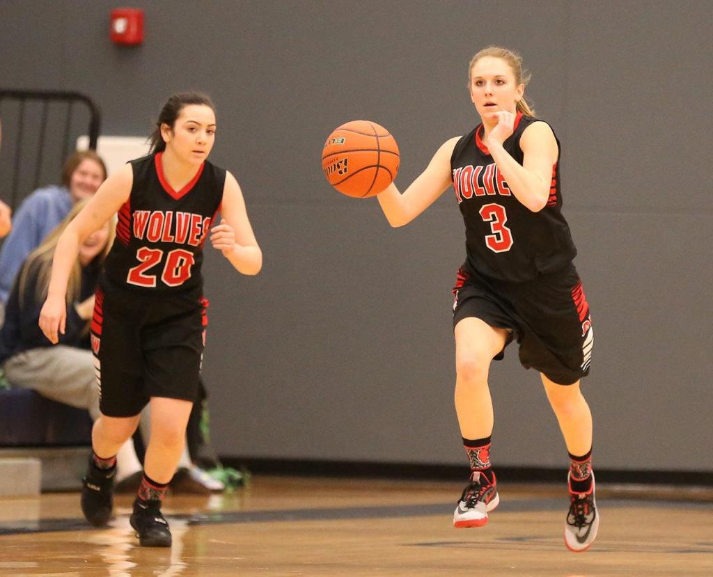 Lauren Grove leads a Coupeville fastbreak as Kalia Littlejohn (20) fills a lane. (Photo by John Fisken)