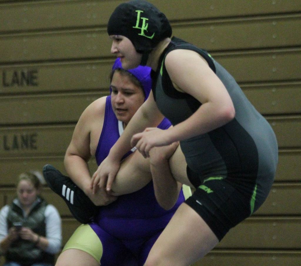 Wendoyn Martinez gets a leg up on Lynden&rsquo;s Brandy Vis. (Photo by Jim Waller/Whidbey News-Times)
