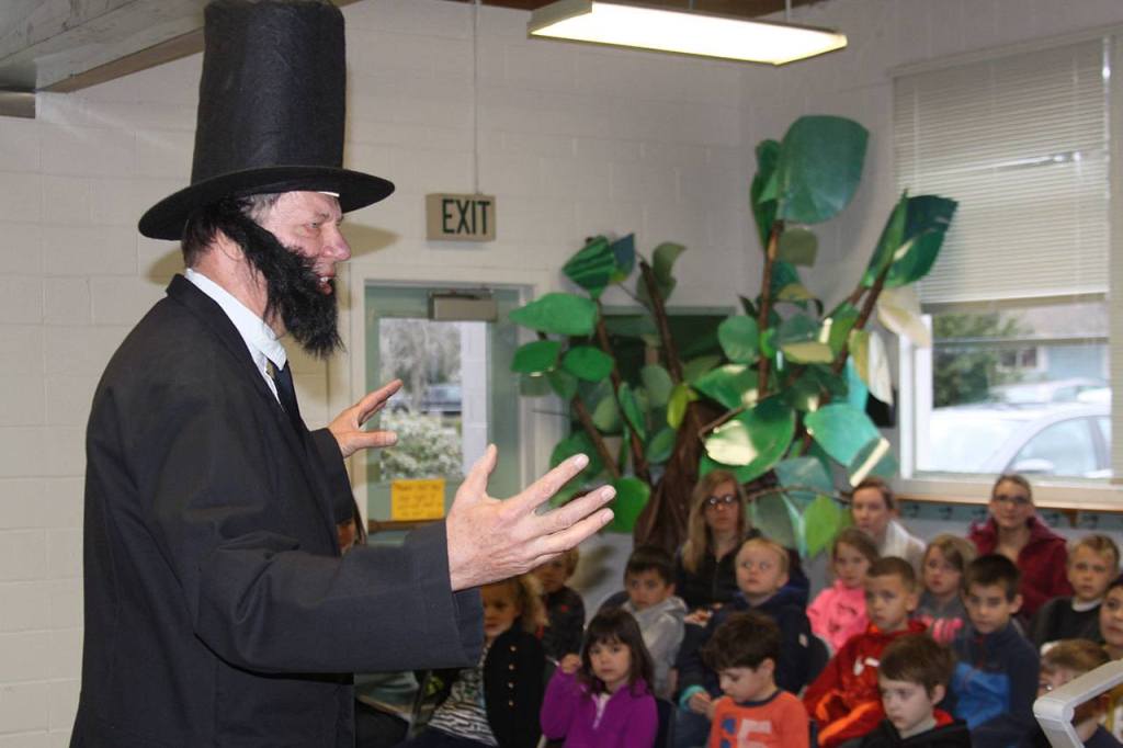 Alan Schell of Oak Harbor dresses up as Abraham Lincoln and impersonates the former U.S. president in the spirit of President&rsquo;s Day Wednesday, Feb. 15, 2017 at Oak Harbor Christian School. Children from kindergarten through sixth grade attended the address. Photo by Ron Newberry/Whidbey News-Times