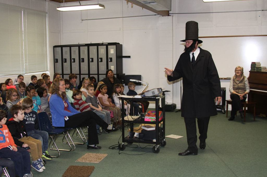 Alan Schell of Oak Harbor dresses up as Abraham Lincoln and impersonates the former U.S. president in the spirit of President&rsquo;s Day Wednesday, Feb. 15, 2017 at Oak Harbor Christian School. Children from kindergarten through sixth grade attended the address. Photo by Ron Newberry/Whidbey News-Times
