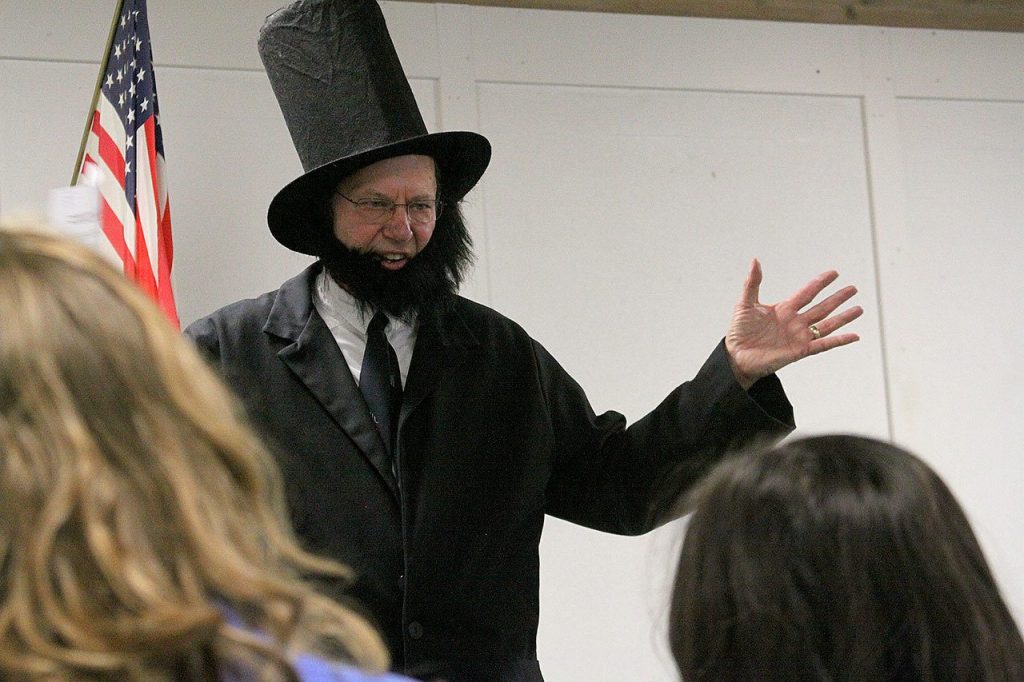 Alan Schell of Oak Harbor dresses up as Abraham Lincoln and impersonates the former U.S. president in the spirit of President&rsquo;s Day Wednesday, Feb. 15, 2017 at Oak Harbor Christian School. Children from kindergarten through sixth grade attended the address. Photo by Ron Newberry/Whidbey News-Times
