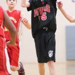 North Whidbey seventh-grader Ben Servatius launches a jump shot. (Photo by John Fisken)