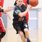 Shawn Day, a North Whidbey seventh-grader, attacks the Oak Harbor defense. (Photo by John Fisken)