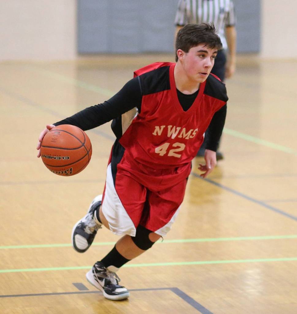 Tyler Zenger, a North Whidbey eighth-grader, looks for an opening in the Oak Harbor defense. (Photo by John Fisken)