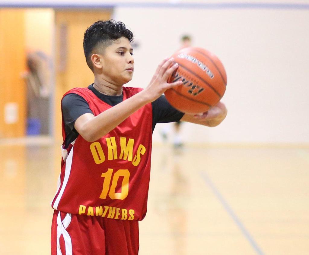 Oak Harbor eighth-grader Cameron Asinsin looks for an open teammate in Tuesday&rsquo;s win. Asinsin tallied 6 points, 4 rebounds, 1 block, 2 steals and 10 assists. (Photo by John Fisken)