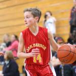 Oak Harbor seventh-grader Will Rankin looks over the defense. Rankin had 6 points, 5 rebounds, 2 blocks and 7 steals in the game. (Photo by John Fisken)