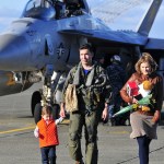 Lt. Cmdr. Kevin Jones assigned to Tactical Electronic Warfare Squadron 130 is greeted by his family upon returning home to Naval Air Station Whidbey Island, Wash. Dec. 30, 2016. Photo by Michael Watkins/Whidbey News-Times