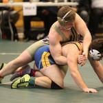Oak Harbor&rsquo;s Nick Dugin, top, tangles with Everett&rsquo;s Jacob Leonard. Dugin won the match 11-4 on the way to placing fourth. (Photo by John Fisken)