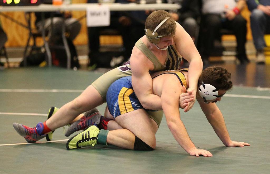 Oak Harbor&rsquo;s Nick Dugin, top, tangles with Everett&rsquo;s Jacob Leonard. Dugin won the match 11-4 on the way to placing fourth. (Photo by John Fisken)