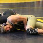 Oak Harbor&rsquo;s Michael Fisken nearly pins Josh Brown of Edmonds-Woodway. Fisken beat Brown 15-2 and eventually placed sixth in the tournament. (Photo by John Fisken)