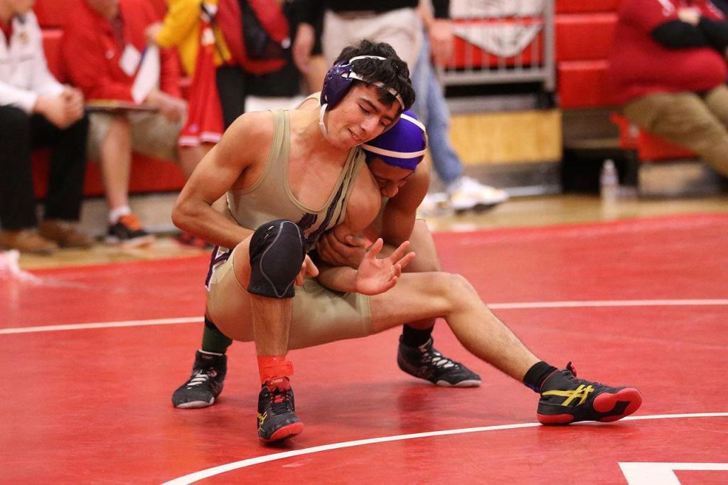 Oak Harbor teammates Caleb Fitzerald, front, and Zion Gomez square off in the match for third and fourth places at the Wesco North Tourament. Gomez won 11-3. (Photo by John Fisken)