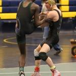 Blake McBride, right, tries to trip up Edmonds-Woodway&rsquo;s Salihou Fatty in the title bout at 132 pounds. Fatty won 10-5 to claim first. (Photo by John Fisken)