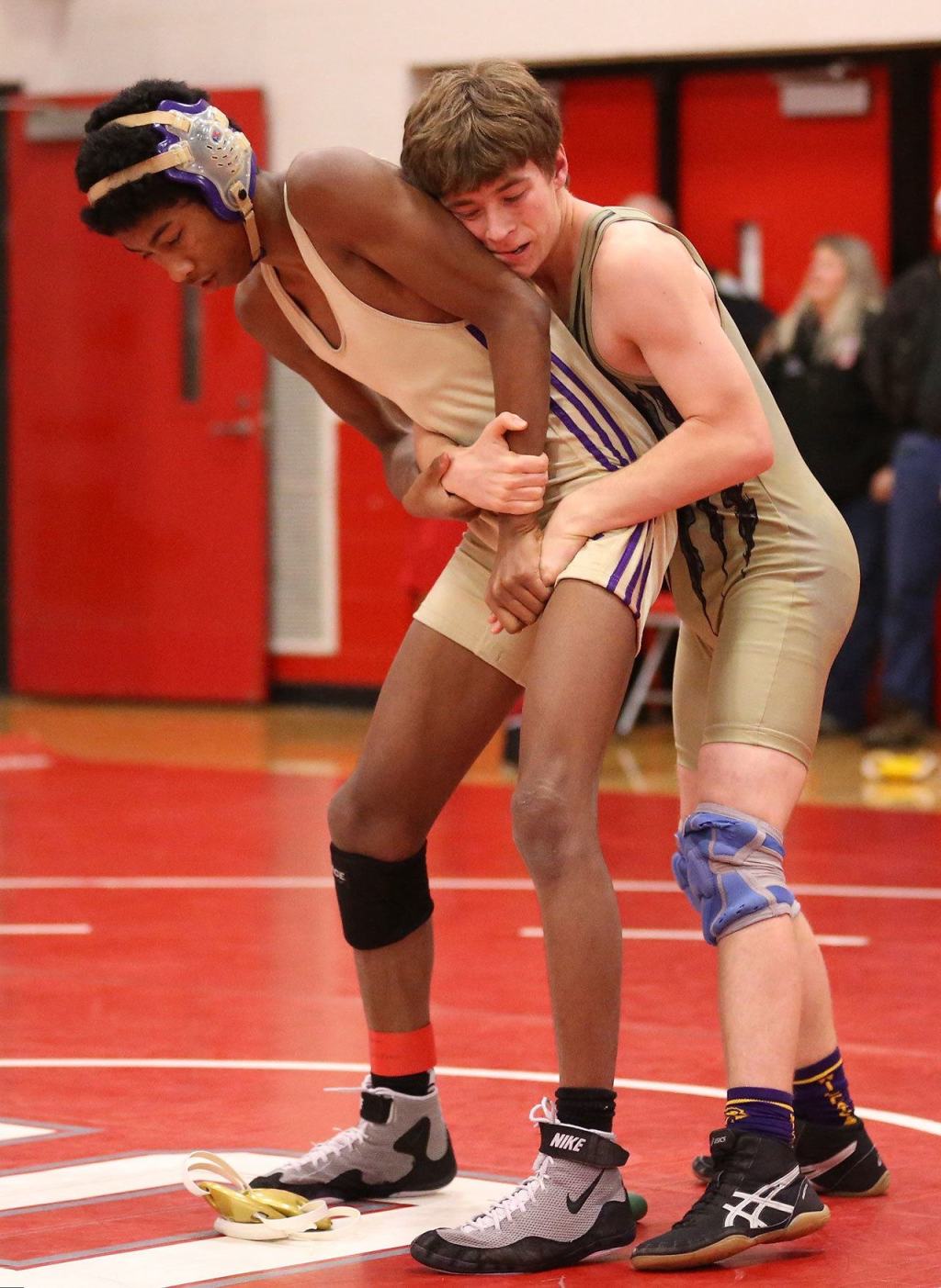 Oak Harbor teammates Tayvion Shaw, left, and William Nickelson meet in the fifth/sixth-place match won by Nickelson 4-3. (Photo by John Fisken)