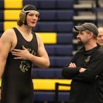 Sam Zook discusses his win with coach Larry Falcon. (Photo by John Fisken)