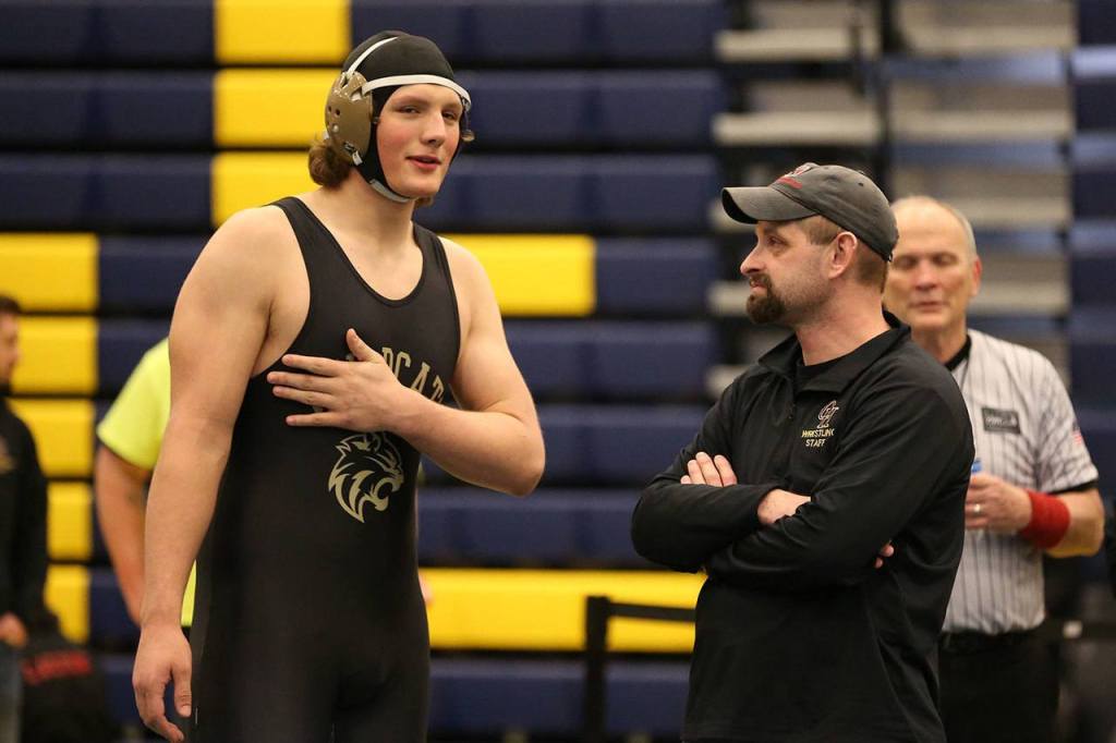 Sam Zook discusses his win with coach Larry Falcon. (Photo by John Fisken)