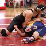 Sam Zook, left, defeats Arlington&rsquo;s Tristan Emery in the championship match at 285 pounds. (Photo by John Fisken)