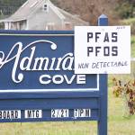 A sign mounted to an entrance sign to Admiral&rsquo;s Cove reveals good news Friday, March 3, 2017 for residents awaiting test results from water samples taken from their community wells last month: No contaminants were detected. In the background, outside of Admiral&rsquo;s Cove, is a guesthouse on property where contaminants were found in a private well. Photo by Ron Newberry/Whidbey News-Times