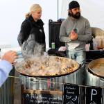 The seafood dishes from Paella House of Port Townsend were a crowd favorite. Below, champion of the Saturday mussel-eating contest, Ryan Leckie of Bellingham, celebrates his win.                                Photos by Patricia Guthrie/Whidbey News-Times