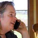 Georgie Smith, Coupeville fourth-generation farmer, speaks to an employee with Skagit Farmers Supply about a soil test that was supposed to be conducted on her farm Wednesday. From her kitchen window, Smith can see the debris pile that remains of the family&rsquo;s historic barn that burned down Monday night. Photo by Ron Newberry/Whidbey News-Times