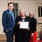 Chris Renfro, left, and Amy Jorden, right, present Janet Burchfield with the 2017 Business Person of the Year award. Photo by Sean Callahan/Island Life Photography