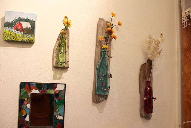 Art created by Whimsies shop owner Charlotte Gray includes bottles made into wall vases and mosaic mirror creations. Photo by Patricia Guthrie/Whidbey News-Times