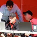 Cody Staker, left, Bob Martin and Jon Roberts check out the results of one of the events. (Photo by Jim Waller/Whidbey News-Times)
